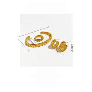 Detailed view of gold stainless steel jewelry set with celestial sun and moon carvings
