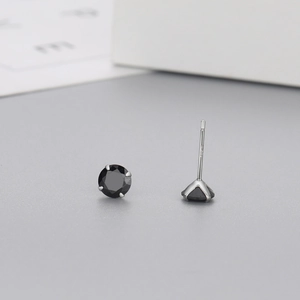 Macro shot of S925 sterling silver studs with black zircon and four-prong setting