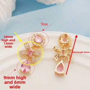 Detail view of 14K gold-plated flower pendant with pink zircon and dimensions of 26mm