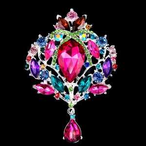 Close-up of a vintage rhinestone brooch with a teardrop pendant and multicolor gems