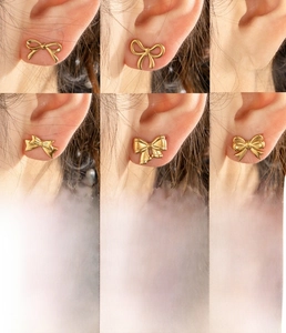 Detailed close-up of vintage gold bow earrings in titanium steel with vacuum plating finish
