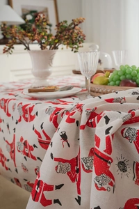 Detail of Christmas tablecloth showing linen texture and festive Santa Claus print