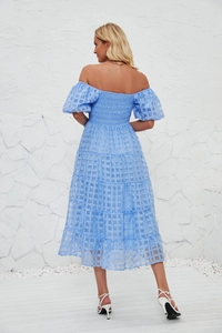 Detail showing the light blue textured fabric and layered tiered skirt of the summer dress