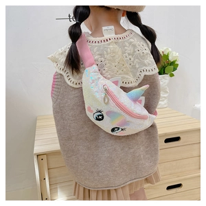 Detail of sequin unicorn waist bag showing rainbow ears and pink strap on a child