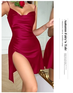 Detail of satin dress featuring a cowl neckline and high side slit in deep red