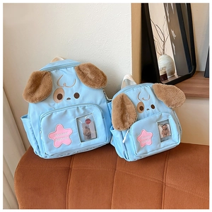 Macro detail of sky blue puppy backpack set with plush texture and stars for kids
