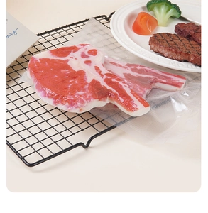 Dettaglio realistico di bistecca Tomahawk artificiale sottovuoto per esposizione ristorante