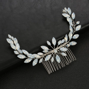 Detail of silver bridal hair comb featuring marquise-cut stones and floral wire patterns