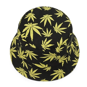 Top-down view of black bucket hat featuring yellow cannabis leaf patterns on canvas fabric