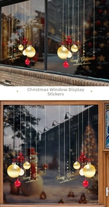 Close-up of red and gold Christmas ball window stickers with Merry Christmas greeting