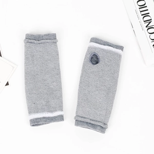 Close-up of grey striped knitted arm warmers with thumb holes and fine stitching