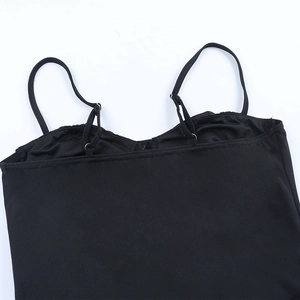 Detail of adjustable thin spaghetti straps and flat neckline on black elegant dress