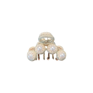 French palace style hair claw clip with pearls on gold metal base over white background