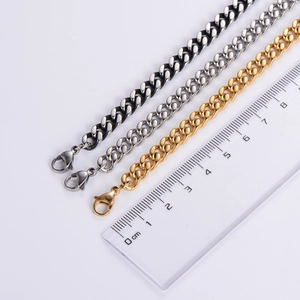 Detailed close-up of 6mm polished stainless steel Cuban link chains in gold, silver, and black