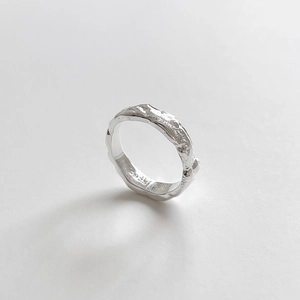 Detail view of adjustable S925 sterling silver ring with hammered lava texture finish
