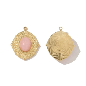 Detail of pink stone gold pendant with vintage floral border from front and back view