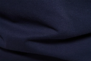 Detailed macro view of dark blue business polo shirt fabric showing fine textile texture