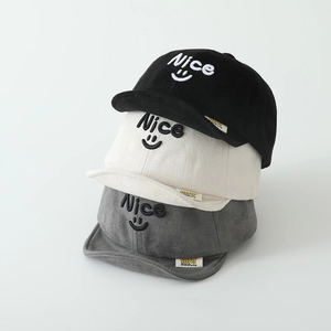 Three kids' suede baseball caps in black, cream, and grey with 'Nice' smiley embroidery