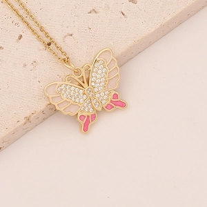 Elegant gold butterfly necklace with pink and white enamel wings and sparkling rhinestones