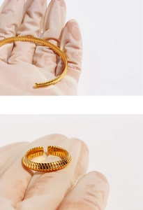 Detail shot of gold-plated corrugated snake texture open ring with metallic luster