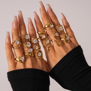 Gold stainless steel stackable ring set with zircon accents on model hand