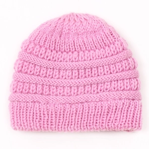 Close-up of pink ribbed knit beanie showing soft texture and warm stretch fabric detail