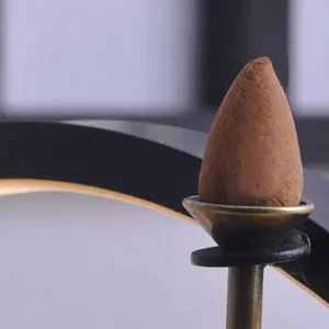 Metallischer Rückfluss-Räucherkerzenhalter in Bronzeoptik mit mattbraunem Räucherkegel
