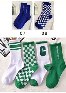 Detail of checkered and striped crew socks featuring citymore 1985 text embroidery