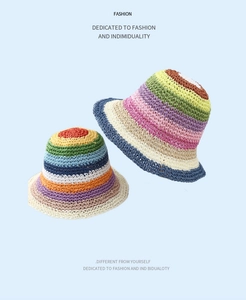 Detail of colorful rainbow striped crochet straw sun hats with vibrant woven texture
