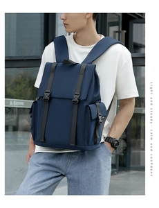 Detail of navy blue flap backpack with secure buckle straps for commute and travel