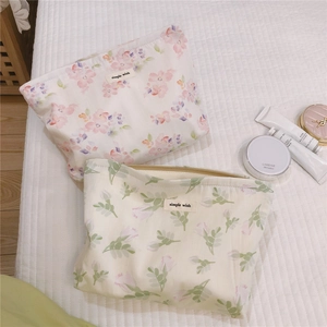 Floral makeup bags with simple wish labels shown with premium beauty products