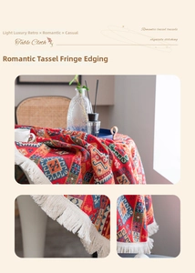 Close-up of bohemian red tablecloth with ethnic geometric patterns and white tassels