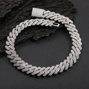 Silver iced out Cuban link chain necklace with sparkling zircon stones on dark wood
