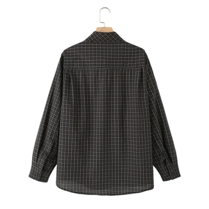 Classic plaid long sleeve shirt in black gray and yellow tones on wooden hanger