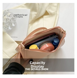 Interior view of the cream shoulder bag showing capacity for phone and cosmetics