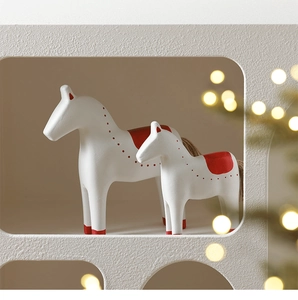 Detailed view of white Dala horse sculptures in two sizes for Nordic home decor