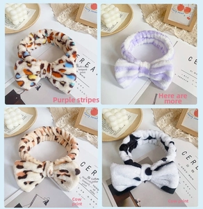 Close-up of four plush headband patterns including leopard, stripes, and cow print
