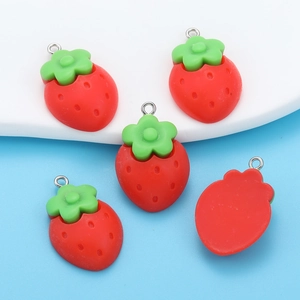 Detailed view of red resin strawberry charms with metal rings for DIY jewelry making