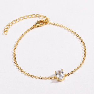 Detailed view of an oval zircon stone in a four-prong gold setting on a fine chain