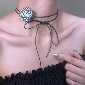 Floral choker necklace featuring a 3D leopard print rose with stylish black cord ties