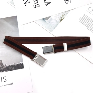 Brown elastic kids belt with black stripes and silver magnetic metal buckle on vintage props