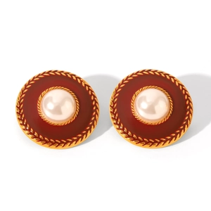 Macro view of vintage earrings with pearl center and burgundy enamel details