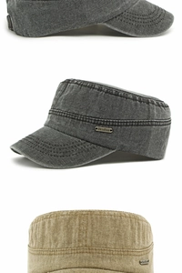 Detail of washed cotton cadet cap featuring vintage metal logo plate and stitching