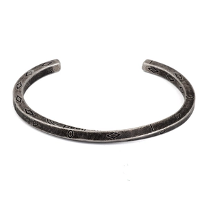 Detailed view of silver stainless steel cuff with geometric patterns and Heart engraving