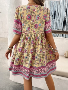 Back view of bohemian floral short sleeve dress in beige with pink and green patterns