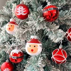 Set of 9 red and white Christmas ornaments with matte and glitter finish on a tree