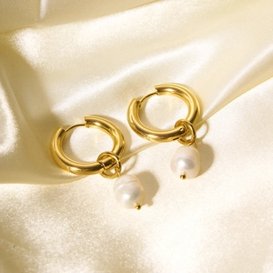 Elegant gold stainless steel hoop earrings with natural freshwater pearl drops on silk