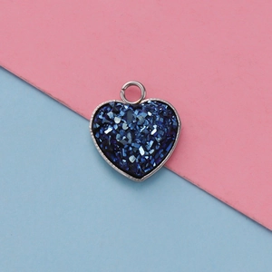 Detail of 13mm heart-shaped stainless steel pendant with blue crystals for DIY jewelry