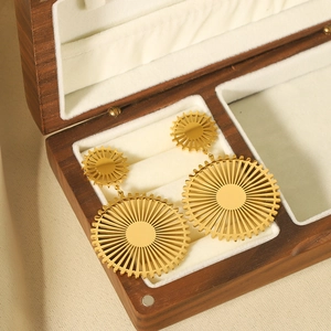 Retro oversized 18k gold stainless steel round sun gear pendant earrings on jewelry box