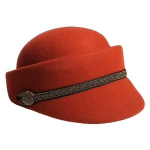 Vintage caramel wool equestrian cap with decorative black and gold braid and metal accent